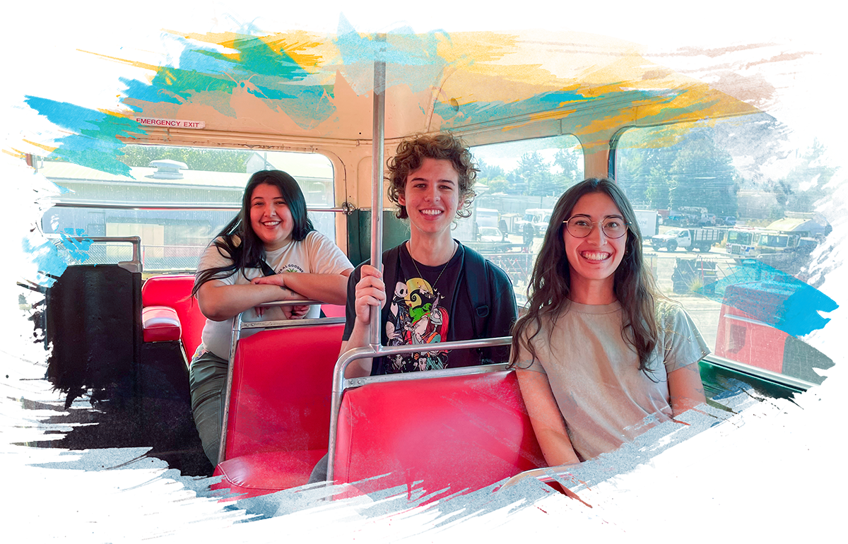 Three students pose on a Unibus