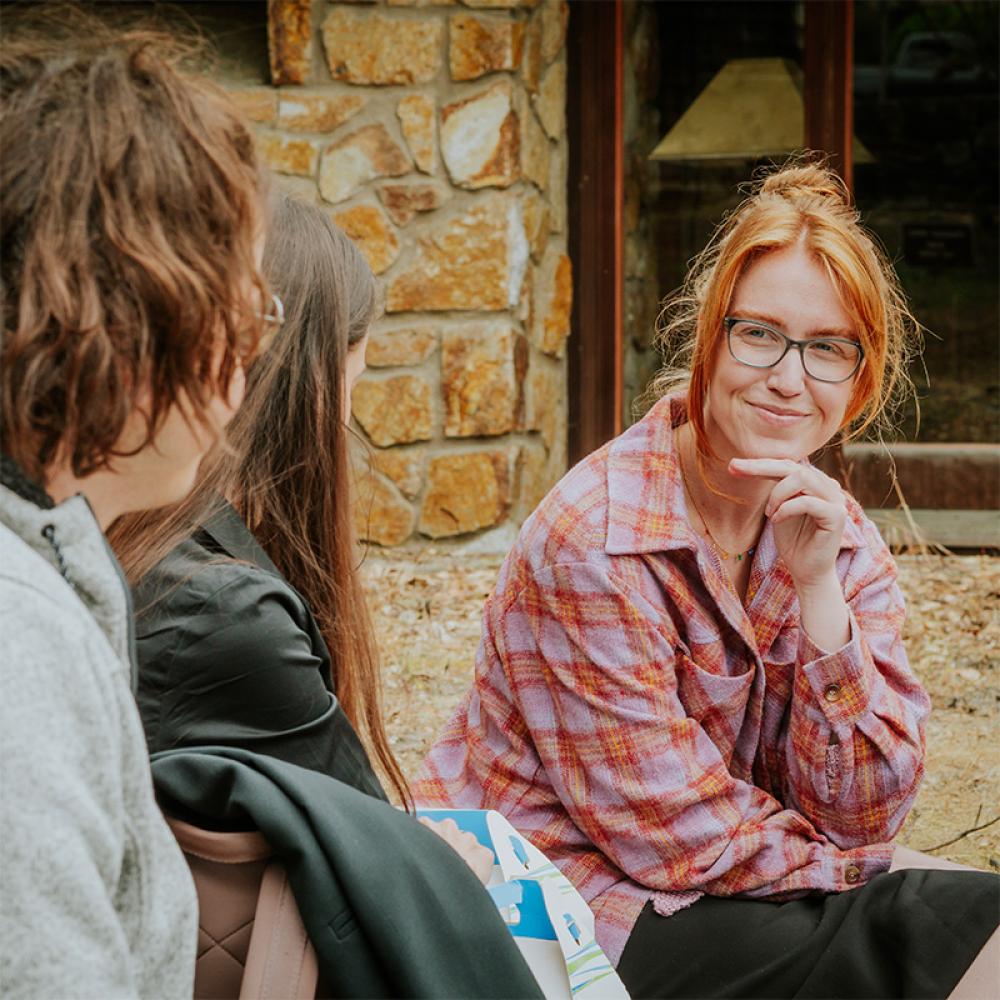 TTP student smiles at other student talking