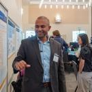 Post-Doctoral researcher presents their research at a conference.